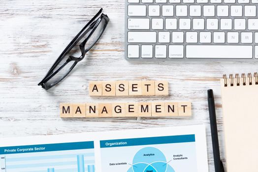 Asset management concept with letters on cubes