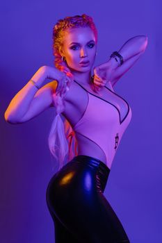 Sexy hot blonde in leggings and top posing