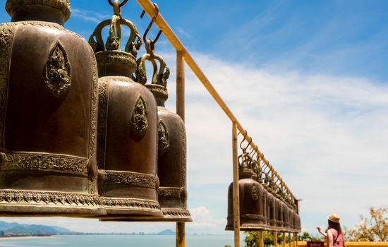 Hanging brass bells arranged on the temple terrace
