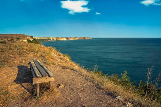 empty bench on the top of sea rocks with a vast view for relaxation