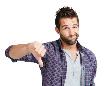 Yeah, maybe next time. Studio shot of a young man showing thumbs down against a white background.