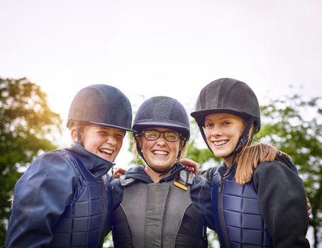 An equestrian team is more like family. Portrait of a group of young friends going horseback riding outside.