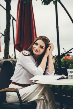 Smiling young dark-haired woman in a cafe