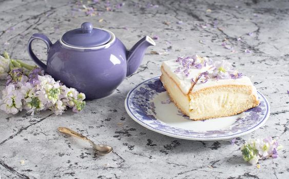 still life with black tea and cheese cake, spring bouquet,delicate lilac flowers