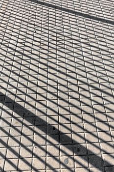 Shadows from the grid on the road, geometric pattern