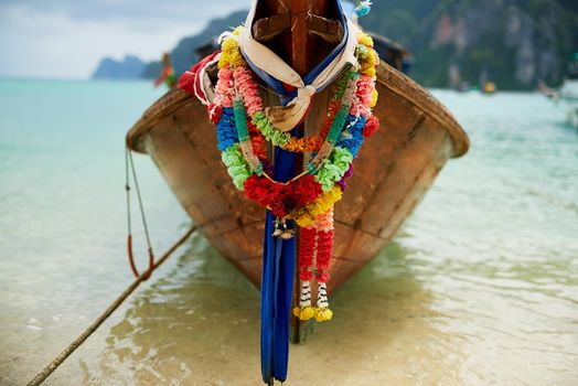 Your island boating experience awaits.... Shot of a boat on the water with a colorful floral garland hanging from it.