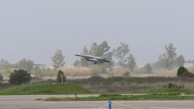 NATO grey warplane take-off in bad weather condition