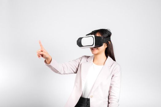 Smiling woman confidence wearing VR headset device touching air during virtual reality experience