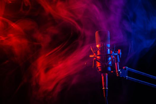 Professional microphone in pink smoke on a black background.