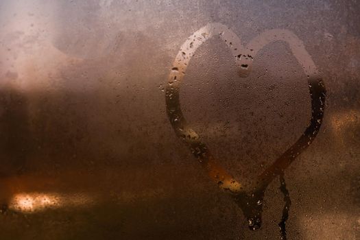 Painted heart on the foggy window. I love you on Valentine's Day.