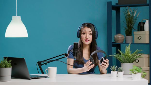 POV of asian woman doing recommendation of modern headphones
