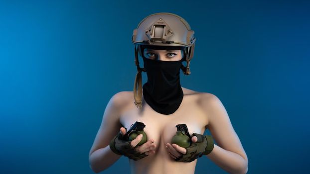sexy soldier girl with grenades on her bare chest wearing a helmet