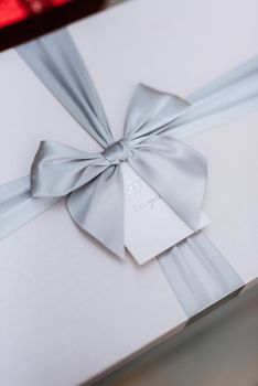 gifts in the hands of a girl in white boxes