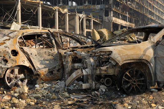Aftermath shell of civilian bombed city damage car. 2022 Russian invasion of Ukraine war torn city destroyed car burn out. Bomb attack Russia war damage Ukraine city war destruction Russian aggression