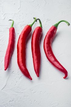 Whole red chili peppers, on white background, top view or flat lay