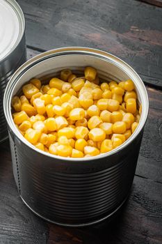 Canned corn, on old dark wooden table background