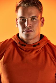 Living a healthy lifestyle makes me confident. Studio portrait of a handsome young male athlete posing against an orange background.