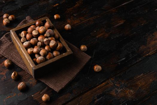 Hazelnut nut health organic brown filbert, on old dark wooden table background, with copy space for text