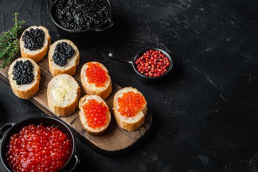 Sandwiches with red and black caviar , on black background with copy space for text