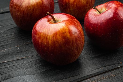Red apple, on black wooden table background