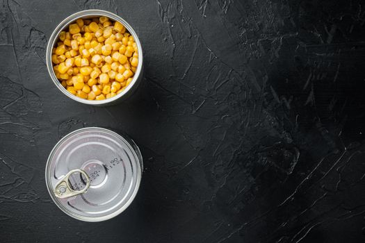 Canned sweet corn, on black background, top view flat lay with copy space for text