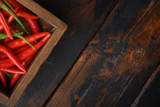 Hot Red thai pepper, in wooden box, on old dark wooden table , top view flat lay, with copy space for text