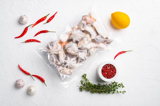 Frozen seafood pack, on white stone table background, top view flat lay