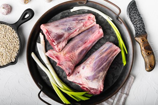 Raw lamb shanks meat, on white stone table background, top view flat lay