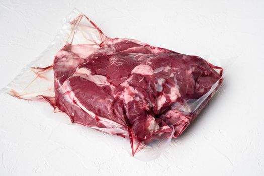 Raw chopped lamb fillet pack, on white stone table background, with copy space for text