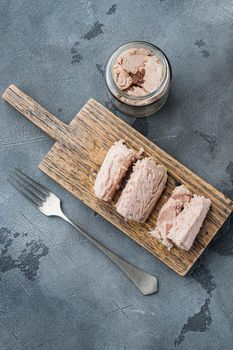 Canned tuna fillet in olive oil , on gray background, top view