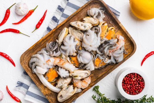 Seafood board with shrimp, squid mussel and octopus, on white stone table background, top view flat lay