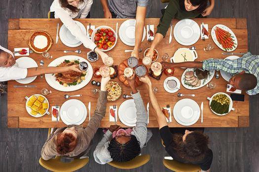 Shot of a group of people sitting together at a dining table ready to eat.