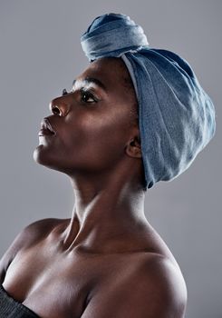 I respect and take good care of myself. Shot of a beautiful young woman wearing a denim head wrap while posing against a grey background.