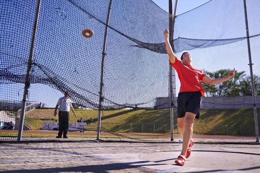 This ones a record breaker. Shot of a young sportsman throwing a discus.