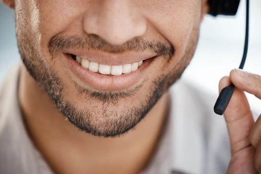 It takes courage to grow up. Shot of a unrecognizable male smiling and working with a headset at work.