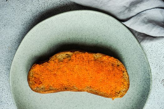 Wholegrain bread toasts with red trout caviar