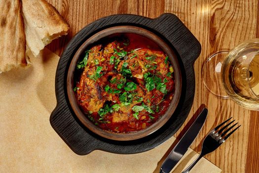 Traditional Georgian Chashushuli of stewed veal with onion, herbs and tomato gravy
