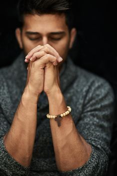 His faith is strong. Closeup shot of a young man praying with his eyes closed.