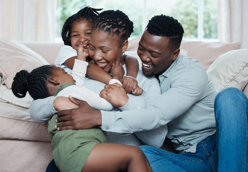 Family feels like a warm, comforting hug. Shot of a happy family relaxing together at home.