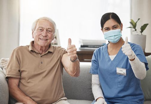 Protect yourself and get vaccinated. Shot of an elderly man and a young female nurse showing a thumbs up during a checkup at home.