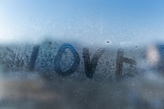 word love on a foggy window
