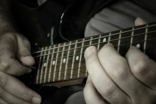 Close-up of man playing lead guitar solo 