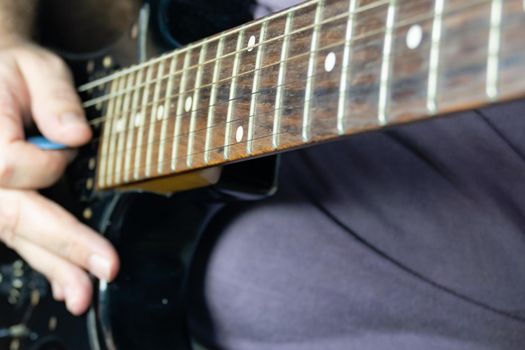 Close-up of man playing lead guitar solo 