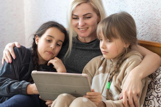 Mother with two children using Tablet PC