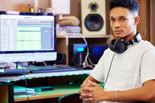 Producing music is what I do. Cropped portrait of a handsome young male music producer working in his home office.