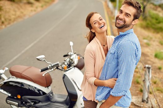 Were having so much fun out on the road. Shot of an adventurous couple out for a ride on a motorbike.