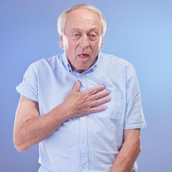 Shortness of breath could shorten your life, get it checked. Studio shot of a senior man experiencing chest discomfort against a blue background.