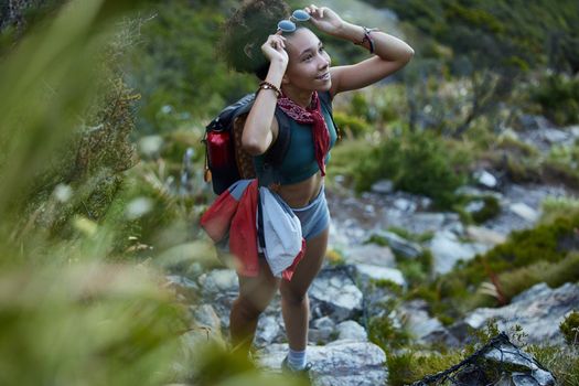 I cant wait to reach the summit. Shot of a young woman out for a hike in the mountains.