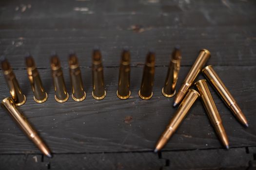 Sharp ammunition stands on a wooden box for the rifle.