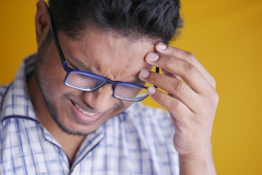 Young man suffering headache, close up